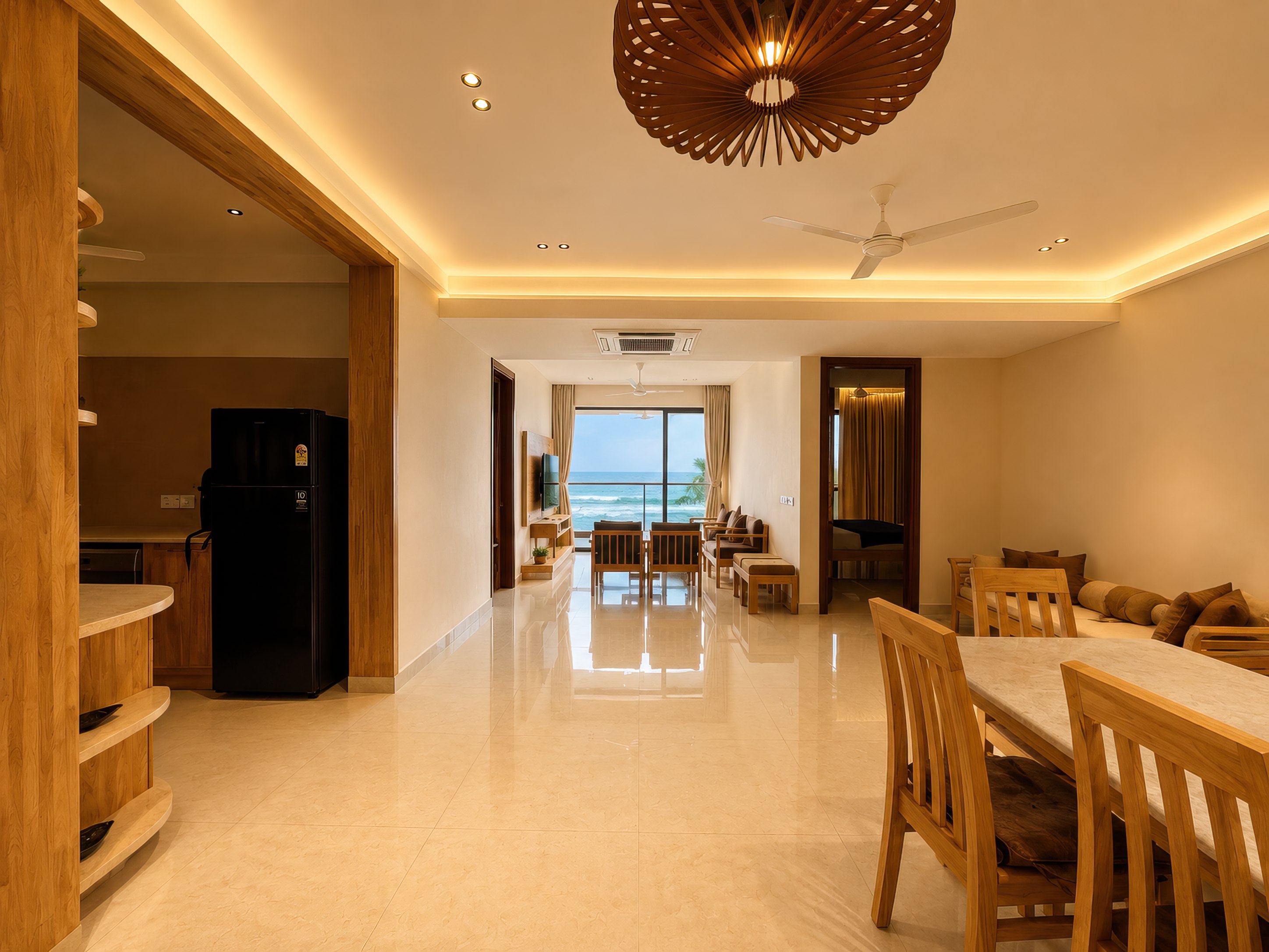 Open living and dining area with the sea framed by the far window