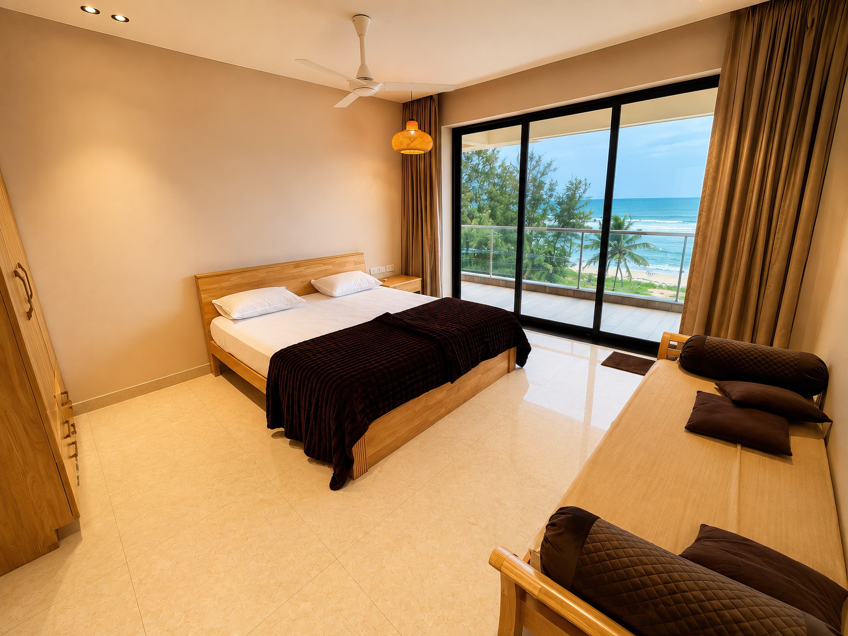 Bedroom with a wooden double bed and sliding doors onto a sea-facing balcony