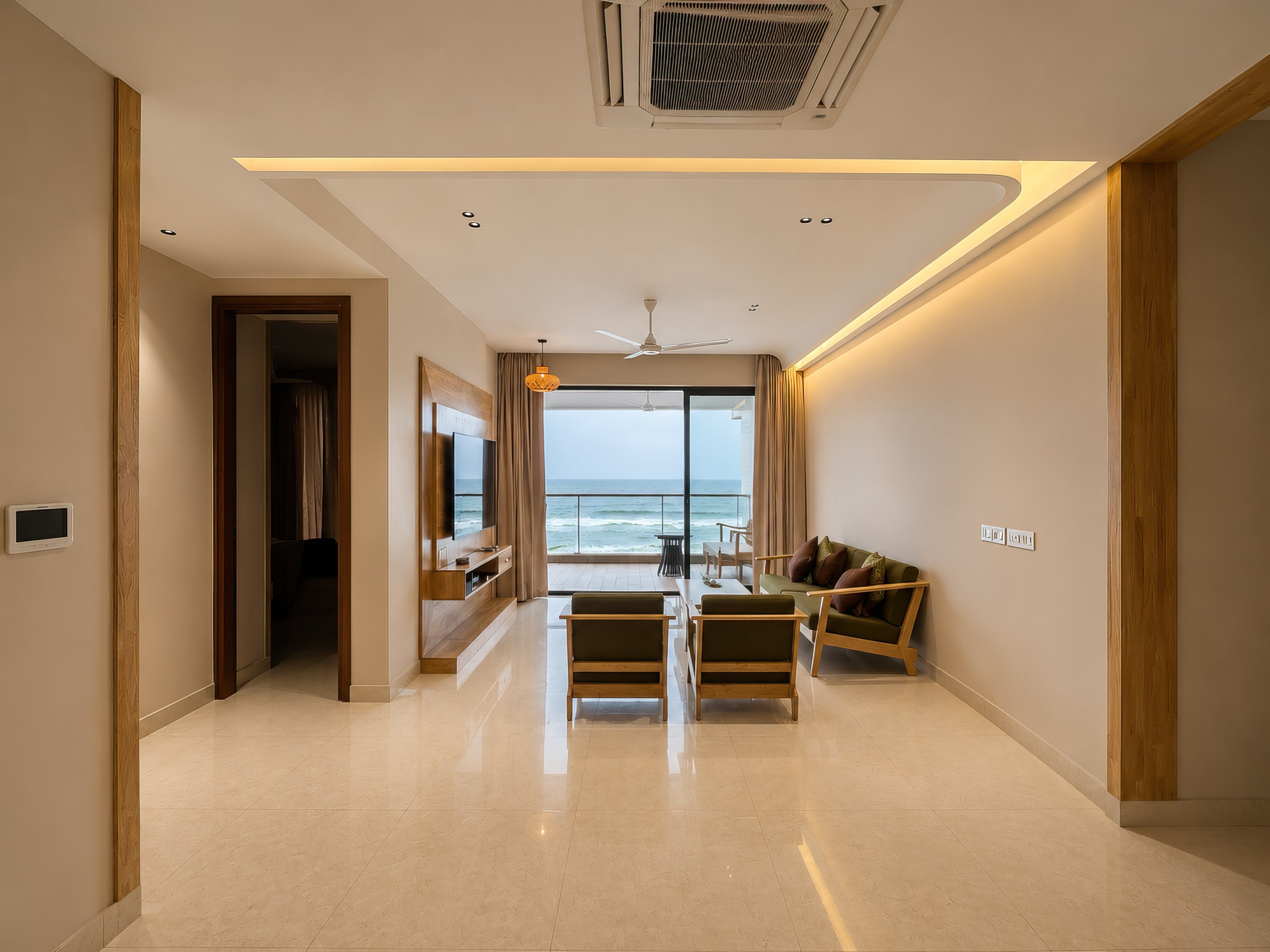 Living room of the 3 BHK, looking out to the balcony and the waves